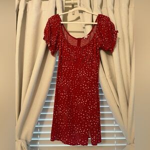 Red mini dress, with white flowers, polka dots, and hearts.